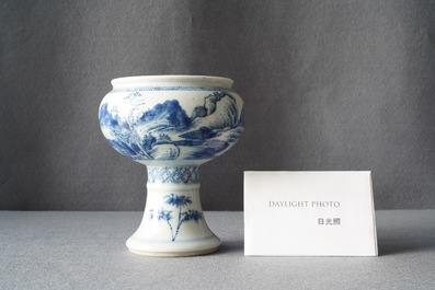 A Chinese blue and white stem cup with a continuous landscape scene, Kangxi/Yongzheng
