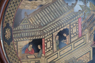 A massive Chinese carved wooden screen with a round famille verte plaque and polychrome lacquer, 19th C.