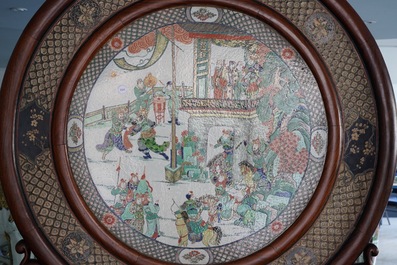 A massive Chinese carved wooden screen with a round famille verte plaque and polychrome lacquer, 19th C.