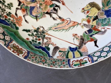 A Chinese famille verte dish with warriors on horseback, Kangxi