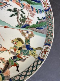 A Chinese famille verte dish with warriors on horseback, Kangxi