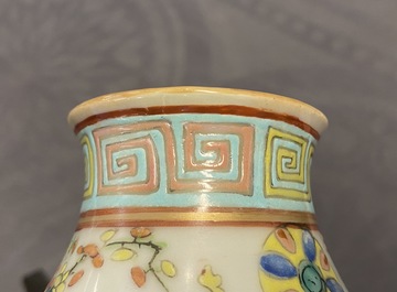 A Chinese famille rose double gourd 'antiquities' vase, 19th C.