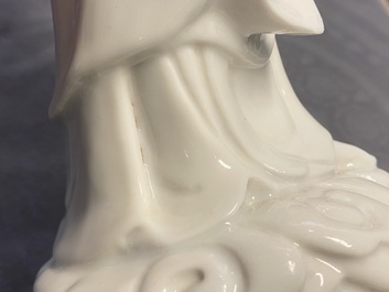 A Chinese blanc de Chine figure of Guanyin on a gilt bronze base, 18/19th C.