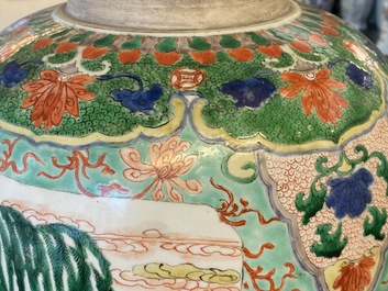 A large Chinese famille verte 'mythical beasts' jar with wooden cover, Kangxi