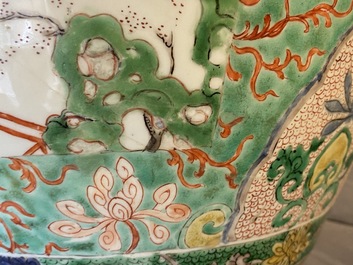 A large Chinese famille verte 'mythical beasts' jar with wooden cover, Kangxi