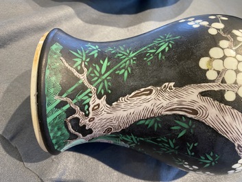 A Chinese famille noire 'magpie and prunus' yenyen vase, Kangxi