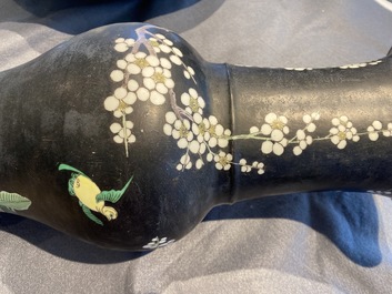 A Chinese famille noire 'magpie and prunus' yenyen vase, Kangxi