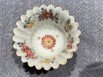A Chinese famille rose cup and saucer and a 'magnolia' cup, Yongzheng