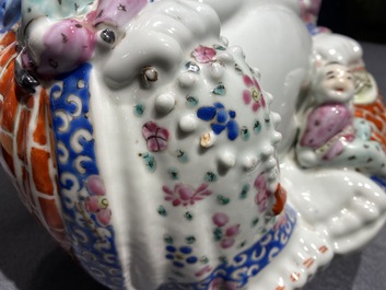 A Chinese blue and white 'dragon' dish and a famille rose figure of Buddha, 19th C.