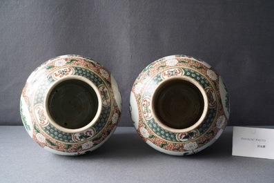 A pair of Chinese famille verte vases and covers, Kangxi mark, 19th C.
