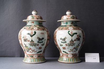 A pair of Chinese famille verte vases and covers, Kangxi mark, 19th C.