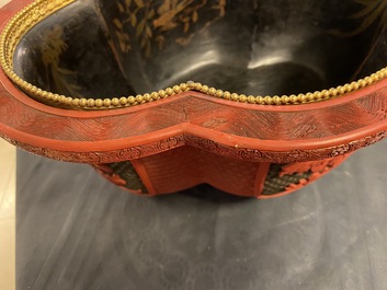 A Chinese quatrefoil jardini&egrave;re in red and black lacquer, Qianlong