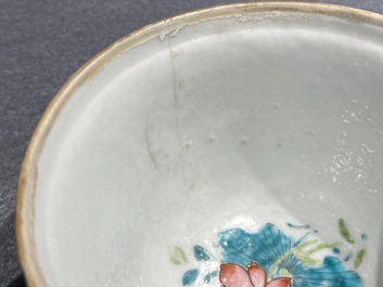 A Chinese famille rose cup and saucer and a 'magnolia' cup, Yongzheng