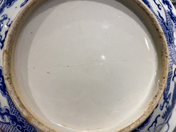 A Chinese blue and white 'dragon' dish and a famille rose figure of Buddha, 19th C.