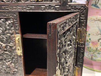 Un petit cabinet en bois sculpt&eacute; &agrave; d&eacute;cor de dragons, Chine, R&eacute;publique
