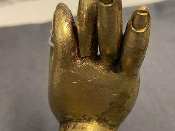 A Tibetan gilt bronze and copper alloy arm of Buddha, Ming