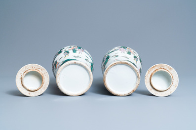 A pair of Chinese famille verte vases and covers with warrior scenes, 19th C.