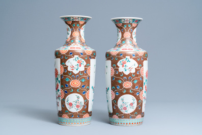 A pair of Chinese famille rose rouleau vases, 19th C.