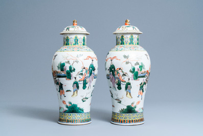 A pair of Chinese famille verte vases and covers with warrior scenes, 19th C.