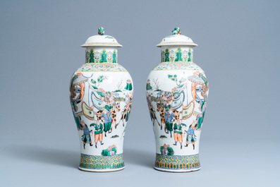 A pair of Chinese famille verte vases and covers with warrior scenes, 19th C.