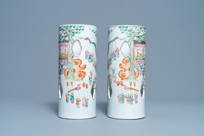 A pair of reticulated Chinese famille rose '100 boys' hat stands, Qianlong mark, 19th C.