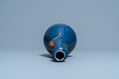 A Chinese monochrome blue garlic head vase with applied biscuit dragon, Jiajing