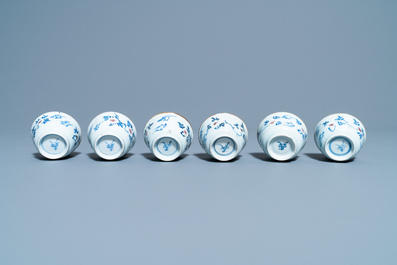 Six Chinese blue, white and copper red cups and saucers, Kangxi