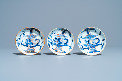 Six Chinese doucai 'dragon' cups and saucers, Kangxi