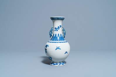 A Chinese blue and white vase with a bird among blossoms, Qianlong mark, 19th C.