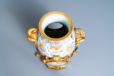 A Chinese gilt bronze-mounted three-piece Canton famille rose clock garniture, 19th C.