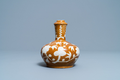 A rare Chinese slip-decorated brown-ground Swatow kendi, Ming