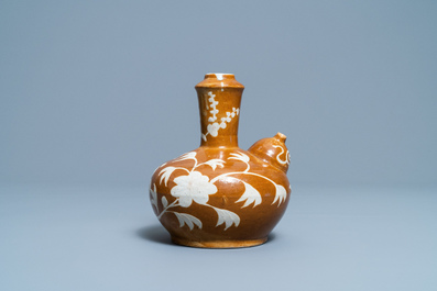 A rare Chinese slip-decorated brown-ground Swatow kendi, Ming