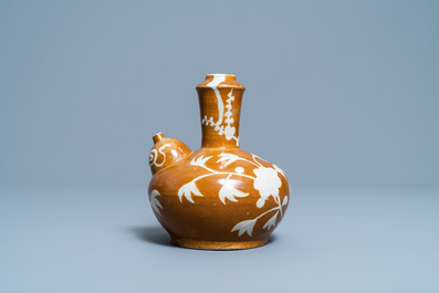 A rare Chinese slip-decorated brown-ground Swatow kendi, Ming
