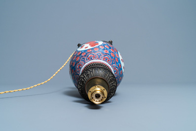 A Chinese blue, white and copper red gilt bronze lamp-mounted vase, 19th C.