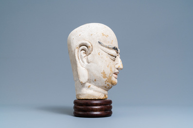 A Chinese painted sandstone head of a luohan, Ming