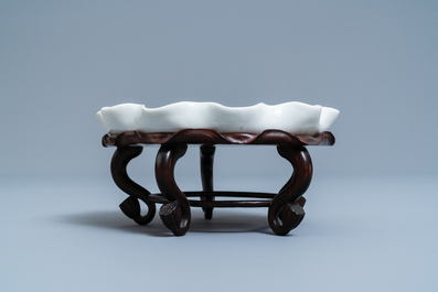 Un lave-pinceaux en porcelaine blanc de Chine figurant une grenouille sur fleur de lotus sur socle en bois sculpt&eacute;, Chine, Kangxi/Yongzheng