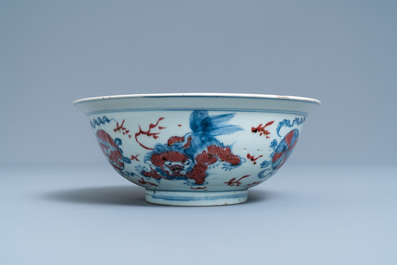 A Chinese blue, white and copper red bowl with Buddhist lions, Qianlong mark, 19th C.