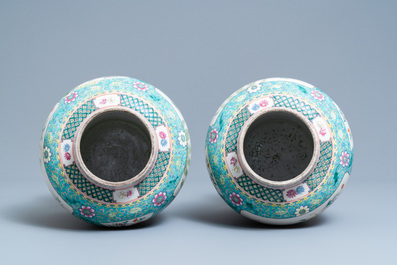 A pair of Chinese famille rose vases and covers, 19th C.