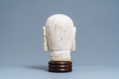 A Chinese painted sandstone head of a luohan, Ming