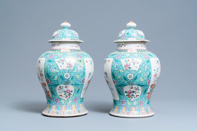 A pair of Chinese famille rose vases and covers, 19th C.