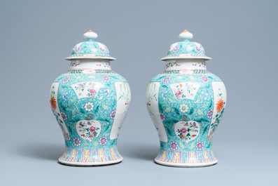 A pair of Chinese famille rose vases and covers, 19th C.