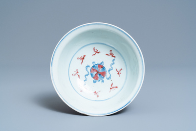 A Chinese blue, white and copper red bowl with Buddhist lions, Qianlong mark, 19th C.