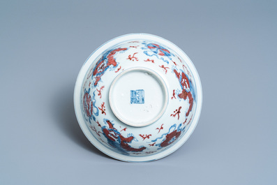 A Chinese blue, white and copper red bowl with Buddhist lions, Qianlong mark, 19th C.