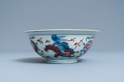 A Chinese blue, white and copper red bowl with Buddhist lions, Qianlong mark, 19th C.