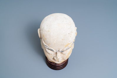 A Chinese painted sandstone head of a luohan, Ming