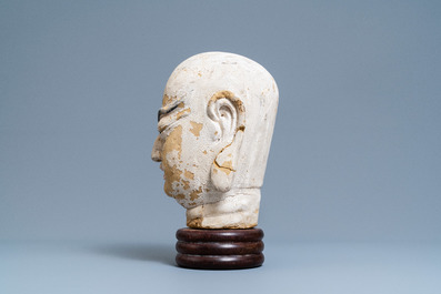 A Chinese painted sandstone head of a luohan, Ming