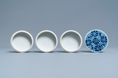 A pair of Chinese blue and white four-tier stacking boxes, a seal paste box and four saucers, 19th C.