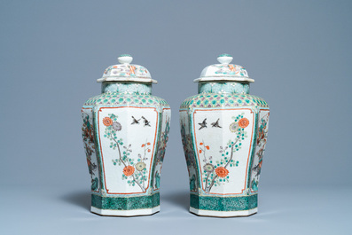 A pair of Chinese octagonal famille verte vases and covers, 19th C.