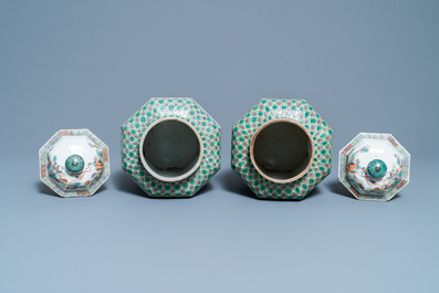 A pair of Chinese octagonal famille verte vases and covers, 19th C.