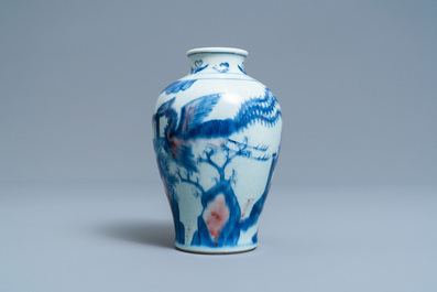 A Chinese blue, white and copper red 'qilin and phoenix' vase, Qing